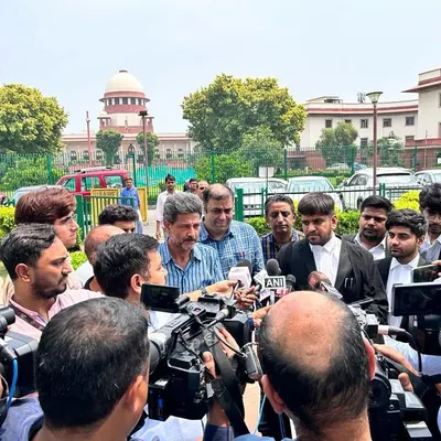Surrounded by reporters from various national news outlets, including ANI and News18, outside the Supreme Court. I believe it's important to provide clear legal context to the public on high-profile cases.
