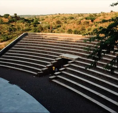 The Aravali Biodiversity Park Amphitheatre in Gurgaon is carved into the natural slope of the land. The seating is created using gabion walls filled with locally sourced stone, making it a sustainable structure that blends seamlessly with the rugged landscape.