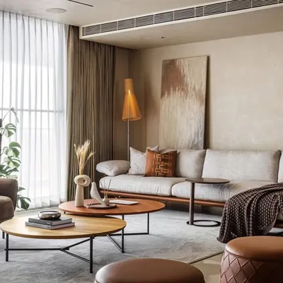 The living room of Terra Gardens is a study in warm minimalism. We used a monochromatic palette of earthy tones, soft fabrics, and natural materials to create a sense of calm and unity. The open-plan layout and simple details are guided by the principle of timeless functionality.