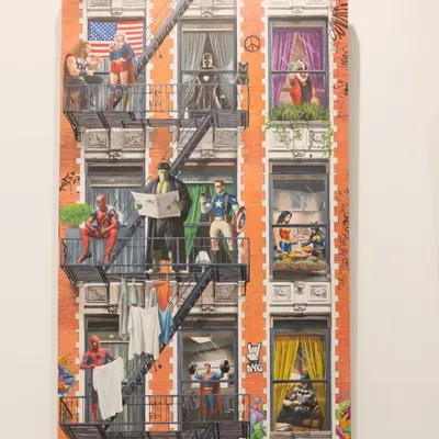 "Ordinary Powers" transforms a city building into a tableau of superhero life. This full view shows characters like Spider-Man, Thor, and Wonder Woman blending the extraordinary with the everyday.