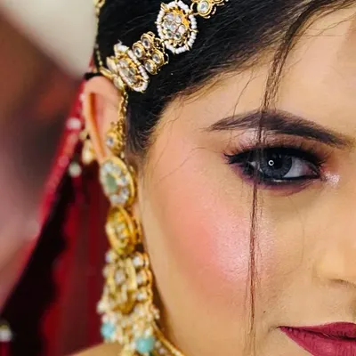 A stunning close-up of the eye. This half-face shot highlights the flawless blending, sharp liner, and the way makeup can accentuate eye color.