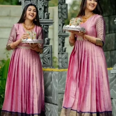 A full view of this gorgeous gown, upcycled from a traditional silk saree. The design retains the original border at the hem while creating a modern, flowing silhouette with elegant pleats.