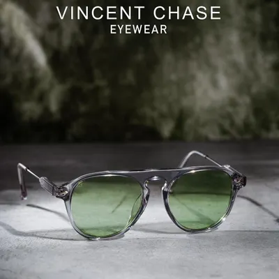 A professional product shot for Vincent Chase eyewear, featuring sunglasses against a textured, atmospheric background. This style elevates the product for a premium brand campaign.