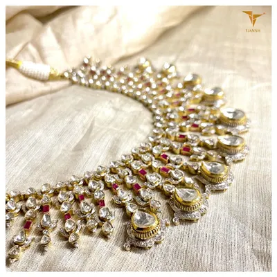 Every detail of this polki necklace is a work of art. A symphony of uncut diamonds and rubies, this piece is a celebration of light, color, and traditional craftsmanship.