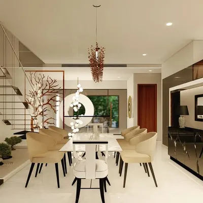 This dining space is set against the backdrop of a modern, floating staircase and an indoor Zen garden. The minimalist white dining table is surrounded by comfortable beige chairs, creating a serene and sophisticated area for meals.