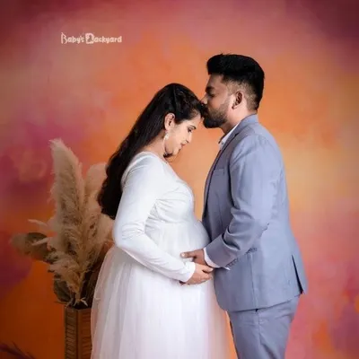 A gentle kiss on the forehead, a hand on the bump. These are the quiet, tender moments of connection we love to capture for expecting couples in our studio.