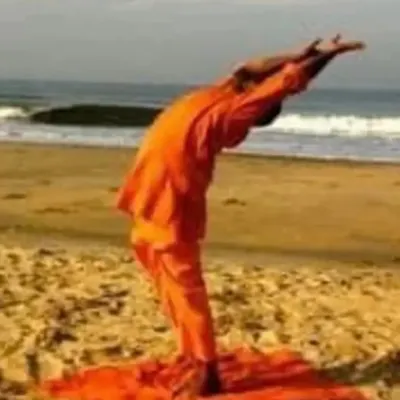 Practicing asanas by the sea connects us to the five elements. Here, I demonstrate a posture on the beach, integrating the rhythm of the waves with the breath, a key part of our international yoga retreats.