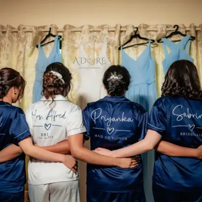 The bride and her tribe. We love planning spinster parties and getting-ready moments, complete with customized satin robes for the bride and her bridesmaids.