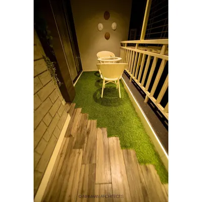This cozy balcony is an extension of the parents' bedroom. We used a combination of wood-finish flooring and artificial grass to create a small, private garden retreat for morning tea.