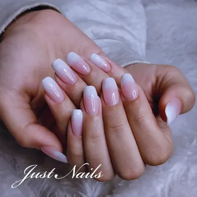 The perfect baby boomer manicure. This design features a seamless pink-to-white ombre on elegant, oval-shaped nails for a clean and classic look.