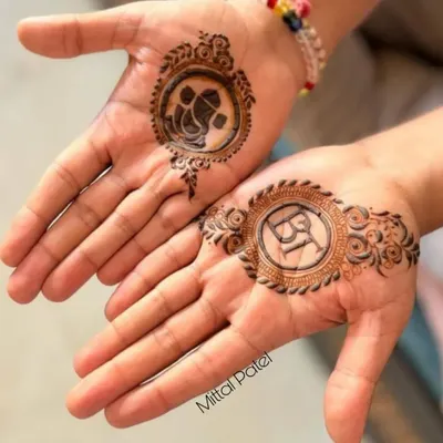Simple and meaningful mehndi for the groom. This design features a Ganesha motif for blessings on one palm and the couple's initials on the other, a perfect way for the groom to celebrate the union.