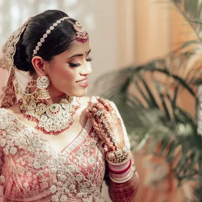 A detailed portrait of the bride, Nupur. I focused on her intricate jewelry and the delicate embroidery of her lehenga, capturing the artistry of her bridal look.