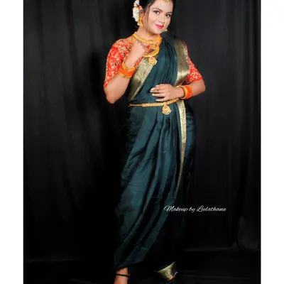 A model showcasing a traditional Marathi look. This features the iconic crescent-shaped bindi and a classic saree drape, paired with festive makeup.