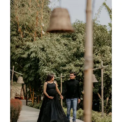 A quiet walk together, hand in hand. These candid-style moments during an outdoor couple's maternity shoot capture the journey you're on together in a relaxed, natural setting.