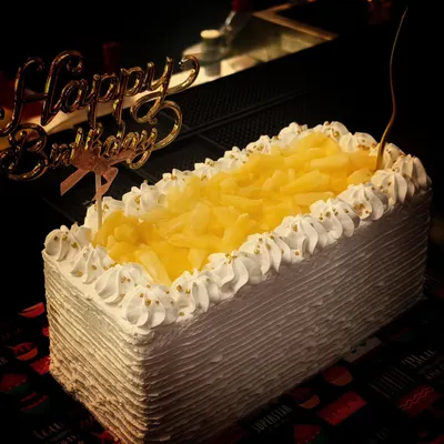 My all-time favourite pineapple cake, ready for a birthday party. This rectangular cake is topped with plenty of pineapple chunks and has a light, fluffy texture that's always a hit.