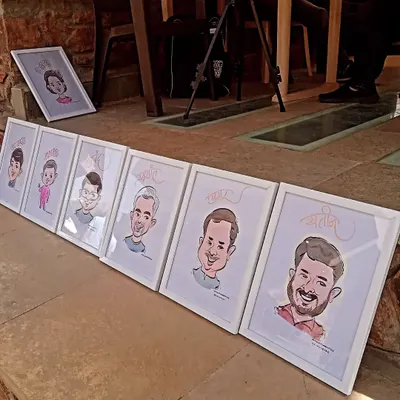 A lineup of my framed caricatures, ready to be gifted at an event. Presenting the art in a clean, white frame makes it a professional and cherished keepsake.