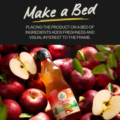 A bottle of Organic India's Apple Cider Vinegar resting on a bed of fresh apples. This simple concept immediately communicates that the product is made from real, natural ingredients.