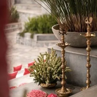 Traditional brass diyas (lamps) and fresh floral arrangements are key elements we use to create an authentic South Indian wedding atmosphere.