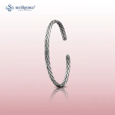 Our braided silver open-cuff bangle, or kada. The oxidized finish gives it a vintage feel, and the open design allows for slight adjustability for a comfortable fit.