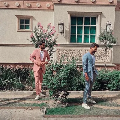 This image captures the versatility of my bespoke suits. It features a range of custom designs, including a standout pink suit, a shimmering light blue, and a classic light grey. It shows how my tailoring can be adapted for a more casual, fashion-forward aesthetic, perfect for making a statement.