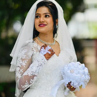 Soft glam for sacred vows. This bride is the picture of grace with a radiant makeup look that enhances her features and a classic red lip for a timeless touch.