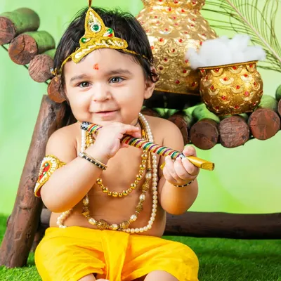 My little Krishna celebrating Janmashtami. The detailed costume, jewelry, and pot of butter make this a truly special and festive portrait.