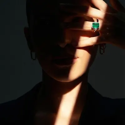 For the bride seeking a touch of colour, this exquisite natural green emerald engagement ring offers a bold and personal statement. The stone's deep hue is captured beautifully in a simple, elegant setting.