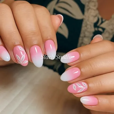 A soft and feminine design featuring a pink to white ombre effect on almond-shaped nails. I added a simple, hand-painted white leaf design to the accent nails for a touch of nature-inspired elegance.