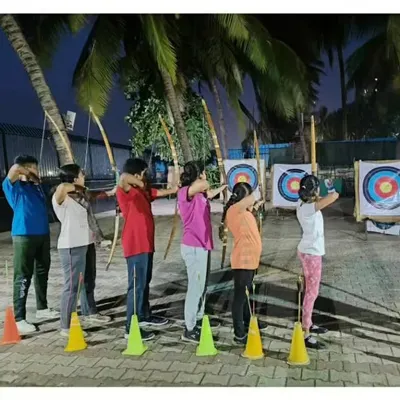 A full shooting line during one of our evening summer camp sessions. Students learn together in a structured environment, practicing their aim on the targets.