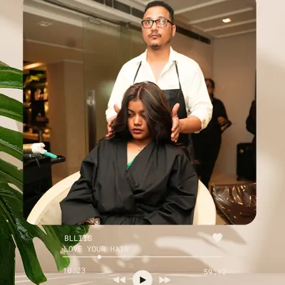 The process begins. Here, our stylist meticulously applies highlights, the first step in a beautiful color transformation that will add depth and dimension.
