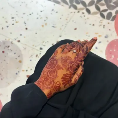 A lovely rose-themed henna design on the back of the hand. This is a great example of a modern, elegant party look, and the mature stain shows a beautiful deep red color.