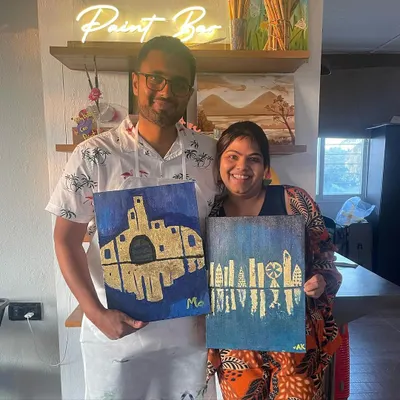 A couple proudly displays their unique gold leaf paintings. It's so fun to see how two people can start with the same idea and end up with such different, personal creations.
