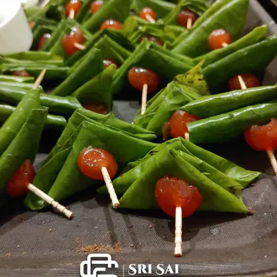 Our classic Maghai Paan, neatly folded and garnished with a candied cherry. This traditional favorite is always a hit at weddings and events.
