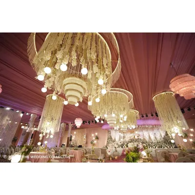 The hall was illuminated by enormous, custom-built chandeliers made from thread curtains and flowers, with light installations that created a magical, floating effect. This demonstrates our ability to design and execute complex, large-scale lighting and structural elements.