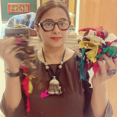 This is me in my studio, holding scraps of fabric that will be upcycled into an improv quilt. For me, there is great satisfaction in creating beautiful things from what would otherwise be waste.