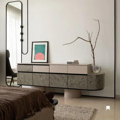 A custom-designed console with a unique swirling veneer finish stands as a functional art piece in the bedroom. Paired with a bespoke full-length mirror, it creates a cohesive and elegant corner that balances form and storage.