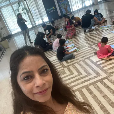 A selfie from our summer workshop at Central Park. In the background, you can see the kids busy with an arts and crafts session, a relaxing and creative part of our day.