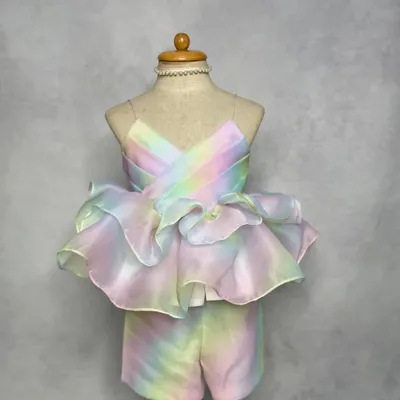 Our most-loved Rainbow Co-ord set. This dreamy pastel outfit features a strappy top with dramatic organza ruffles and matching shorts, perfect for a stylish birthday or vacation look.