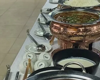 A selection of our North Indian main courses, including a rich dal and a vegetable curry, served in traditional copper pots.