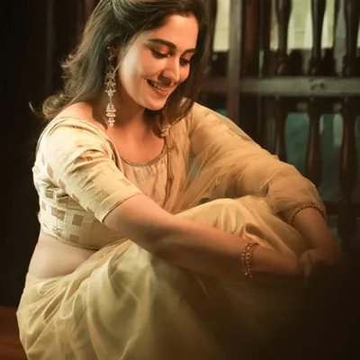 A genuinely happy moment captured in warm, beautiful light. This candid shot of the bride's laughter is what makes a wedding album feel personal and real.