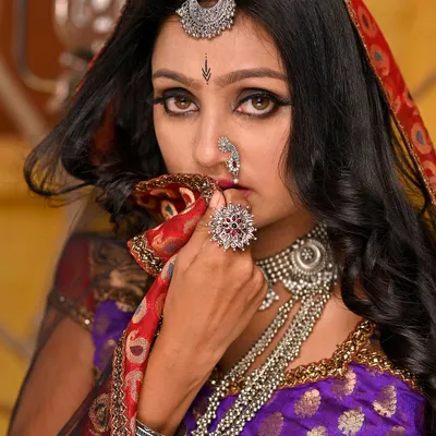 This is from our Rajasthani folk-themed set. We used a warm, earthy-toned backdrop, pottery props, and traditional silver jewelry to create an authentic and evocative story of love and longing.