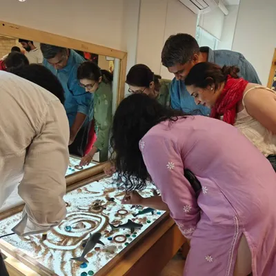 Play is not just for children. During a parent event, adults rediscover their own sense of wonder at the light table, connecting with the materials and gaining a deeper understanding of how their children learn.
