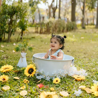 Splish, splash in the sunshine! This outdoor tub session, surrounded by grass and sunflowers, is a perfect example of a fun and unique outdoor shoot.