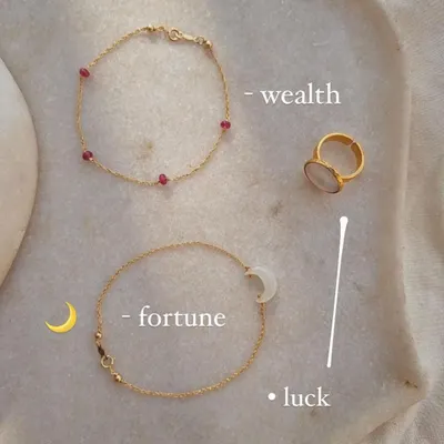 For wealth and passion, I recommend Ruby. This image shows my 'árvat' Ruby Baati Bracelet and 'śaani' White Moonstone Saturn Ring. Ruby is a stone of good fortune, while Moonstone attracts abundance.