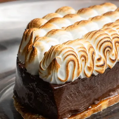 My Hazelnut Chocolate dessert is made for sharing. A crisp praline base, dark chocolate mousse, and soft torched meringue come together to create a sweet ending to a perfect date.