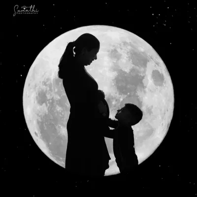 A beautiful and tender silhouette of a mother and her child against a full moon. This shot captures the magical bond between them as they anticipate the arrival of a new family member.