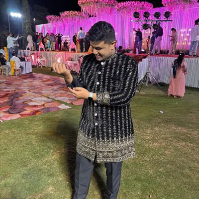 A client looking absolutely ready for a wedding night in our black velvet Jodhpuri. The detailed embroidery shines under the lights, making it a perfect rental for a sangeet or reception.
