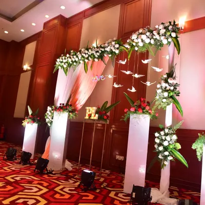 An elegant entrance arch for a Sangeet night. We used white flowers, hanging bird props, and soft lighting to create a dreamy and romantic welcome for the guests.