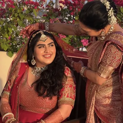 A beautiful, heartfelt moment between our bride Vaishnavi and her mother. We created a minimal and subtle look to let her natural radiance shine through in her red bridal attire.