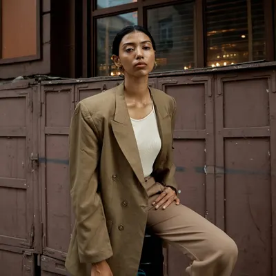 An outdoor portrait session in Mumbai. The earthy tones of the suit and the rustic urban background create a cohesive and stylish look that feels grounded and confident.